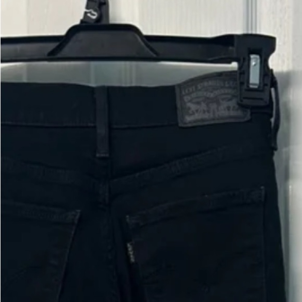 Black mid waisted Levi’s ripped jeans